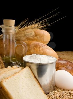 bread and bakery products on wood isolated at black background