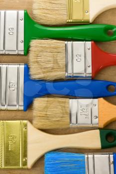 colorful paintbrush on wood background texture