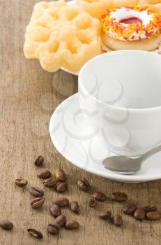 cup with coffee beans at old table