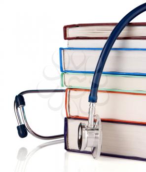 pile of old books and stethoscope isolated on white background