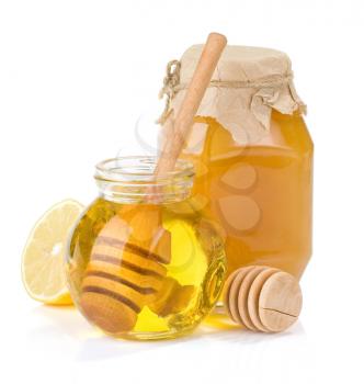 glass jar full of honey and lemon isolated on white background