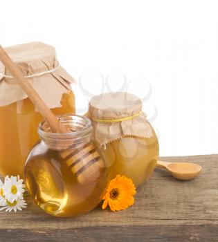 jar of honey and stick isolated on white background