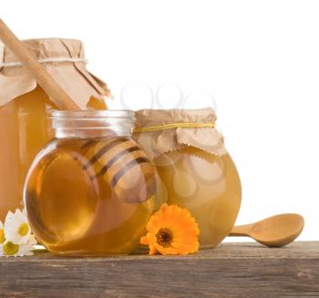 honey in jar isolated on white backgroun