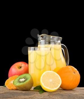 fresh fruits juice in glass and slices isolated on black background