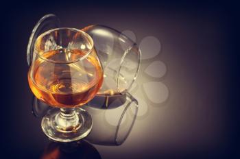 cognac and  glass on black background
