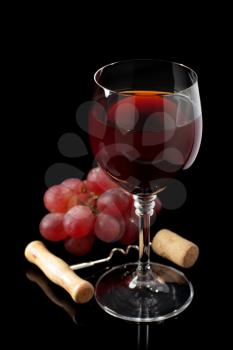 wine glass and grapes on black background