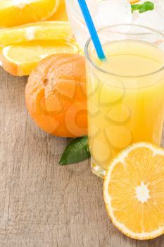 orange juice and slices fruit on wood background