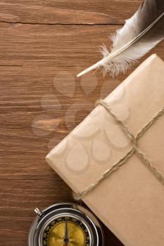 parcel wrapped with brown paper tied with rope on wood background