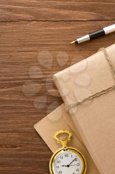 parcel wrapped with brown paper tied with rope on wood background