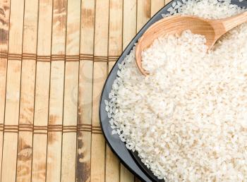 rice and wood plate with spoon on table