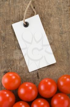 price tag and tomato vegetable at wood background texture