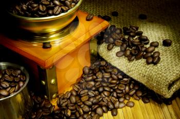 coffee grinder, beans and pot on sacking