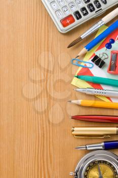 back to school and office supplies on wood background