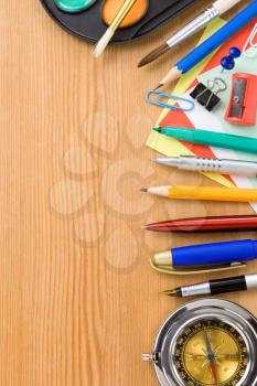 back to school concept and supplies on wood background