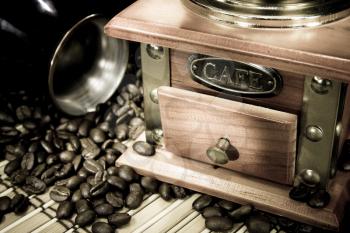 coffee beans, pot and grinder on sacking