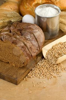 bakery products and grain on wooden texture