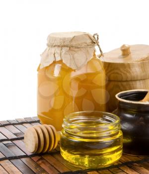 honey and jars isolated on table