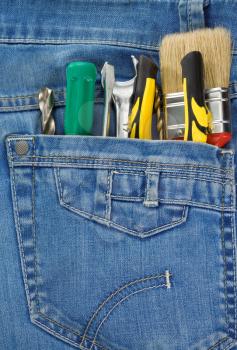 set of tools and instruments in jeans pocket background
