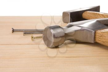 hammer and nail on wood bar isolated on white