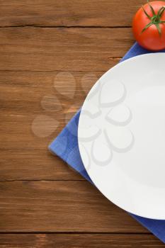 plate at napkin on wooden background
