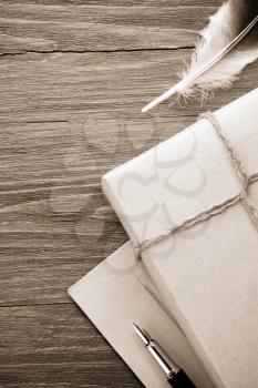 parcel wrapped with brown paper tied with rope on wood background