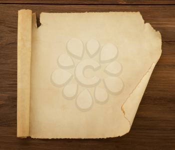 parchment scroll on wood background