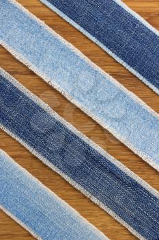 jeans strips at wooden texture background