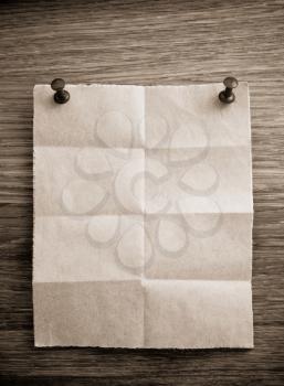 folded note paper on wooden background