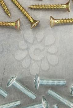 bolts and screws at metal background texture