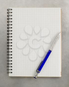 checked notebook at metal background texture