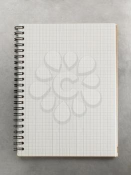checked notebook at metal background texture