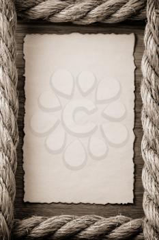 ropes and old vintage ancient paper at wooden background