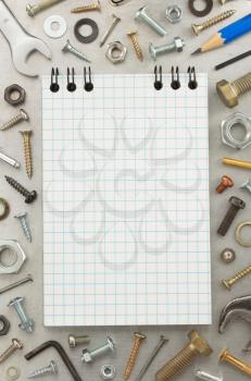hardware tools and notebook at metal background texture