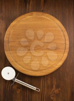 pizza cutting board on wooden background