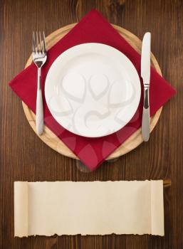 plate, knife and fork  on wooden background