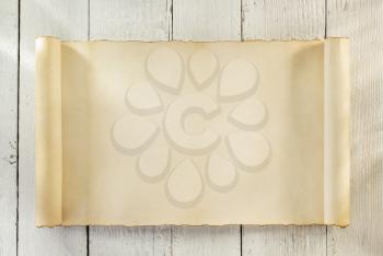 parchment scroll on wooden background