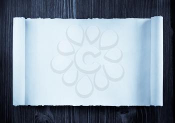 parchment scroll on wooden background