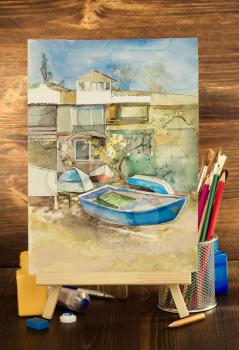 picture frame and paints on wooden background