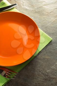 plate, knife and fork on napkin cloth