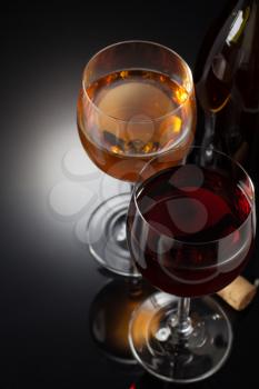 wine and wineglass on black background