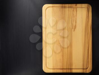 cutting board at wooden table surface