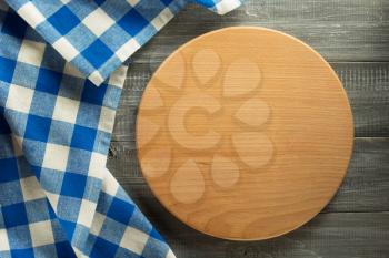 napkin at cutting board on wooden background