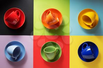 empty cup and saucer at colorful paper background