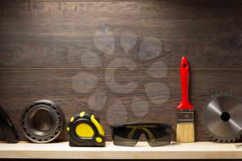 construction tools at wooden shelf background