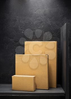 cardboard box on wooden shelf black background surface