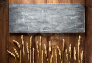 wheat grains on wooden plank background