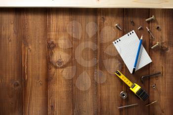 construction tools on wooden plank background