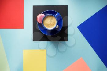 cup of coffee at colorful paper background