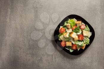 caesar salad in plate at table background