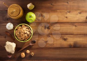 cereal flakes and healthy food on wooden background